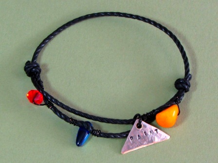 Bracelet - Paint, waxed cotton cord, Picasso Jasper, Swarovski Crystal, glass and hand stamped tag.